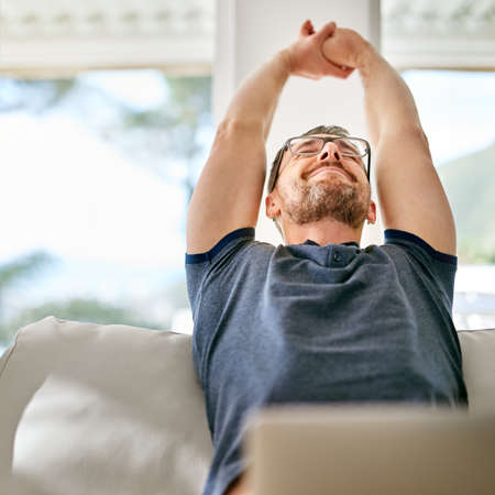 Enjoying his day off. Shot of a handsome mature man relaxing on the sofa at home.
