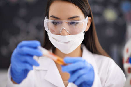 Finally the compound is complete. Shot of a female scientist observing a sample in a test tube.の写真素材