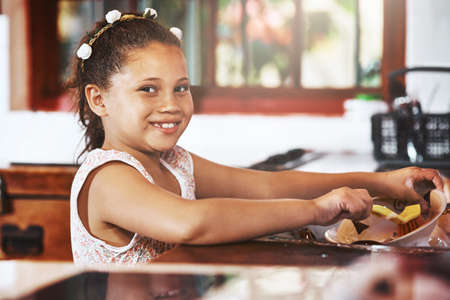 I dont mind helping around the house. Portrait of an adorable little girl washing dishes at home.の写真素材