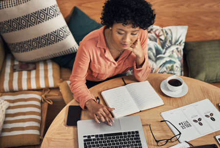I have the internet to thank for helping me grow. Shot of a businesswoman using her laptop while working at a cafe.の写真素材