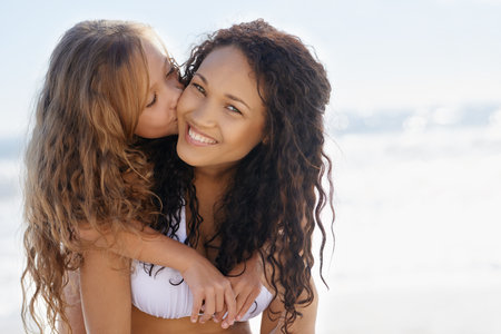 I have the best mum. A young mother and her daughter on the beach.の写真素材