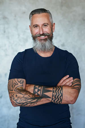 Fierce but always a gentleman. Portrait of a confident middle aged man standing with his arms folded...