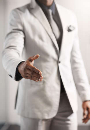 Let me lead you towards business excellence. Closeup shot of an unrecognizable businessman extending a handshake.の写真素材