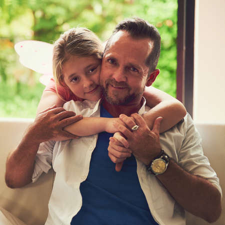 The warmth of love. Portrait of a father spending quality time with his little daughter at home.