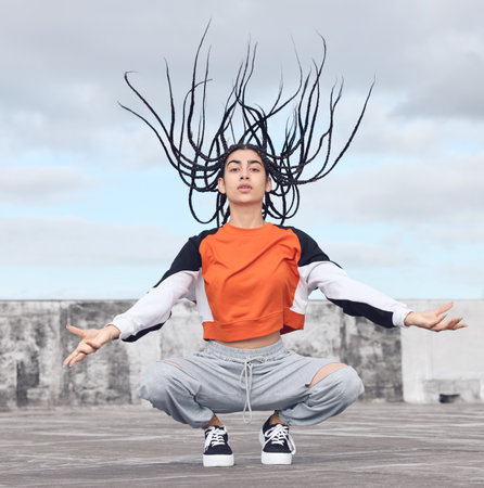 Be the change you want to see. Shot of a young woman out on a rooftop.