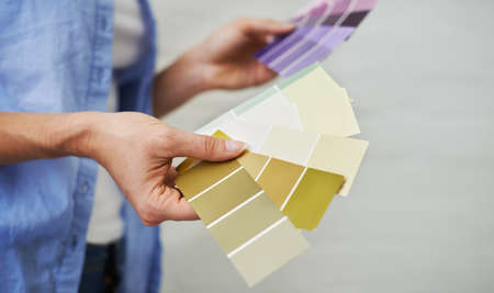 Shes got the right swatch for you. Shot of a woman fanning out color swatches.