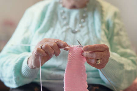 Knitting helps pass the time. Closeup shot of an unrecognisable senior woman knitting.の写真素材