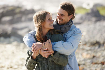 Relaxed romance. Shot of an affectionate young couple spending time together outdoors.