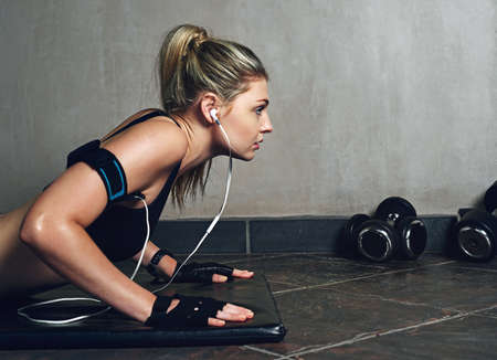 If it was easy, everyone would do it. Shot of a young woman doing push ups.