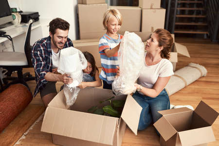 To beginning a new life in a new home. Shot of a young family on their moving day.の写真素材