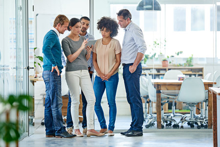 Sharing her ideas with the team. Shot of a group of office colleagues having a discussion over a...