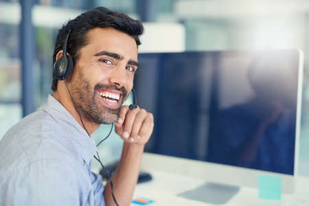 Always online to help. Portrait of a call centre agent working in an office.