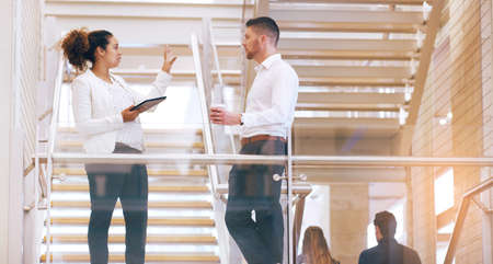 If we look at it from that perspective.... Cropped shot of two young businesspeople having a...