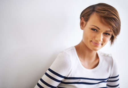 A smile is my favorite accessory. A cropped portrait of a beautiful young woman standing against a...