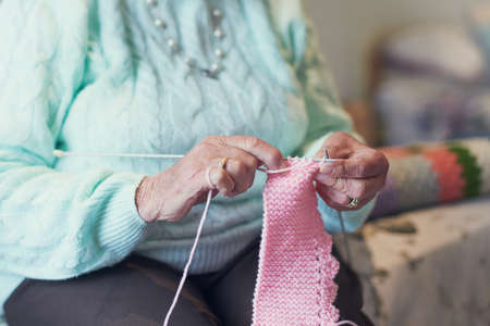 Knitting is a stress-reliever of its own. Closeup shot of an unrecognisable senior woman knitting.の写真素材