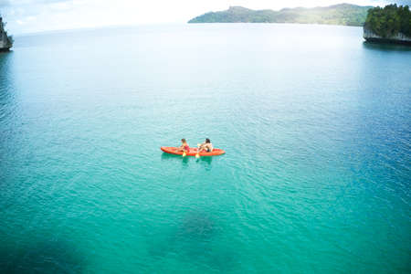 Were paddling away into paradise together. High angle shot of an adventurous young couple canoeing...
