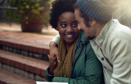 Dont miss me too much while Im in class. Cropped shot of an affectionate young couple on campus.の写真素材