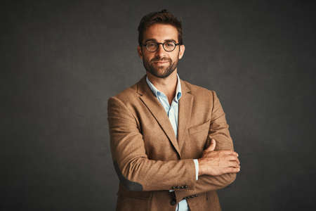 He wears the clothes, the clothes doesnt wear him. Studio shot of a handsome young man posing...