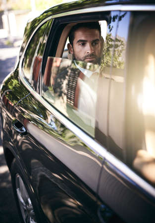 On his way into work. Cropped shot of a handsome young businessman on his morning commute to work.の写真素材