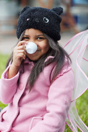 Tea party for one. Shot of a cute little girl having a tea party on her own outside.