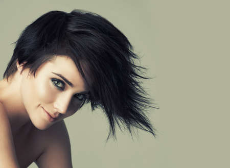 That alternative funky look. A funky young woman with an alternative hairstyle posing in studio.の写真素材