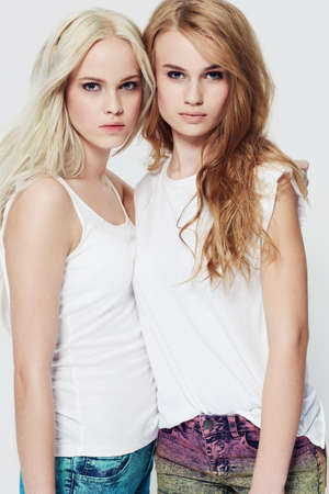 Rocking a casual look. Studio portrait of two young models against a white background.