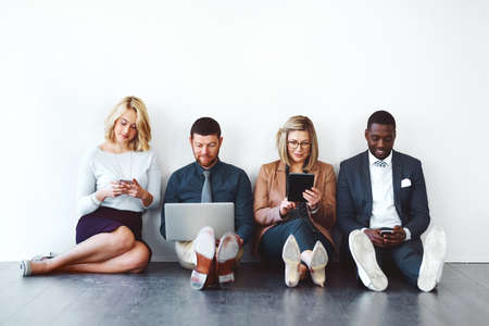 Wireless networking has many advantages to offer. Shot of a group of entrepreneurs using wireless...