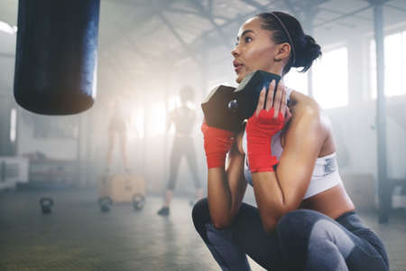 Pressure makes diamonds, hard work makes champions. Cropped shot of a young sportswoman busy working...