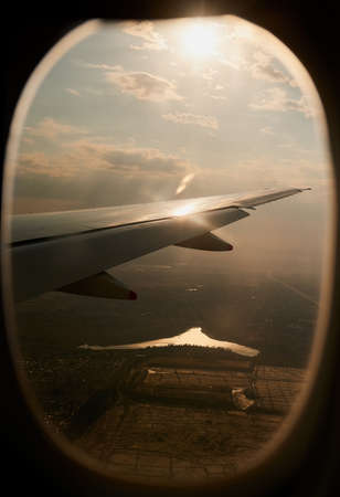 Soaring through the air on silver wings. Shot of the view through an airplane window.の写真素材