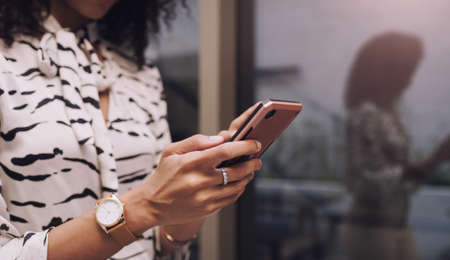 Keep moving and make connections along the way. Shot of an unrecognisable businesswoman using a...