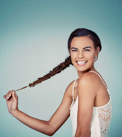 Enjoy your hair especially when its this stylish. Studio shot of a beautiful young woman posing...