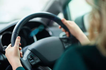 Journeying along. Shot of a woman holding onto a steering wheel while driving.