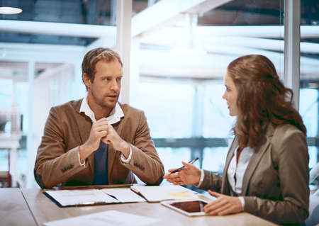 Hes always willing to listen to an idea. Cropped shot of two businesspeople working together in the...