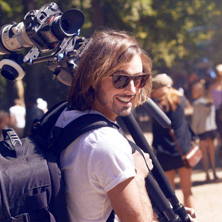 Not prepared to miss a second of the action. Cropped shot of a young cameraman at a festival.