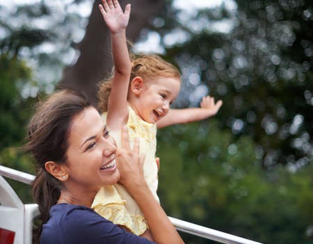 Travel doesnt become adventure until you leave yourself behind. Cropped shot of a mother lifting her...