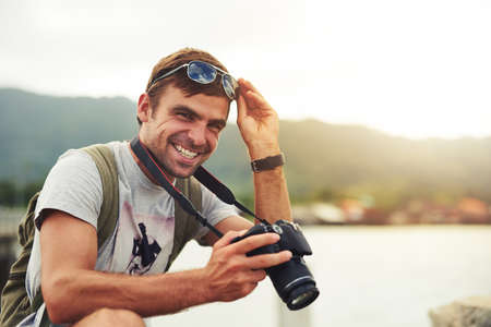 Capture life and the beauty in it. Shot of a young man out with his camera.の写真素材