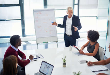 Coming up with the best strategy for their company. Cropped shot of a mature businessman giving a...