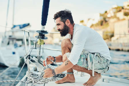 This is where youll find me in my free time. Shot of a mature man out sailing on a sunny morning.の写真素材