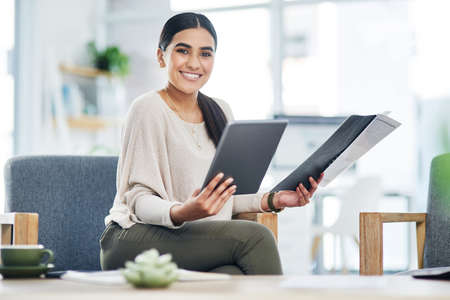 There are tons of apps that could assist you. Portrait of a young businesswoman using a digital...