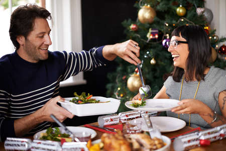 Proud of his Christmas lunch. Shot of a happy young couple eating Christmas dinner.