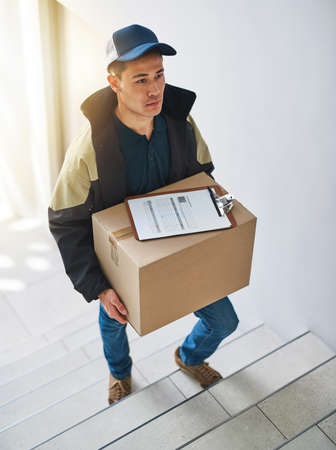 Deliveries done right on time, all the time. Shot of a courier making a delivery in an office.