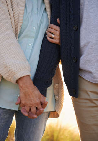 Committed through thick and thin. Cropped view of a senior couple holding hands.の写真素材