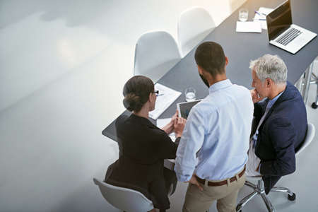 Meeting in progress. Shot of corporate businesspeople having a meeting in an office.