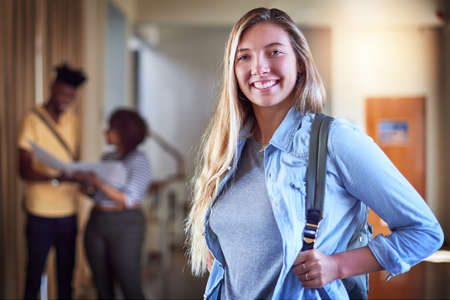 Success starts with having the right attitude. Portrait of a university student standing in a corridor at campus.の写真素材