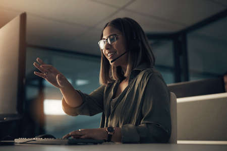 Giving clear instructions for the solutions. Shot of a call centre agent working in an office at...