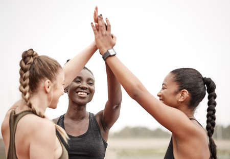 Together well make it to the end. Shot of a group of female athletes high fiving one another.