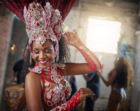 Time stands still over here. Shot of a cheerful young woman wearing festive clothing while dancing...
