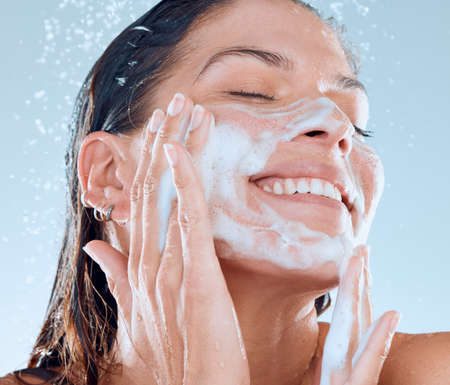 Cleanliness will allow you to radiate with confidence. Studio shot of a young woman washing her face...