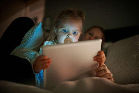 Childhood development in the digital age. Shot of an adorable little girl using a digital tablet...