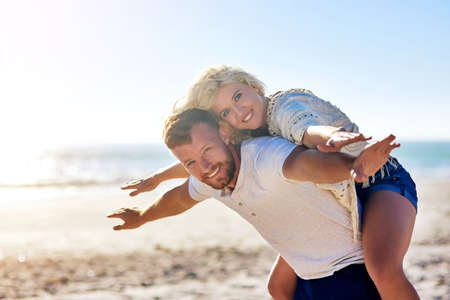 Love life and life will love you back. Cropped shot of n affectionate couple spending the day at the beach.の写真素材